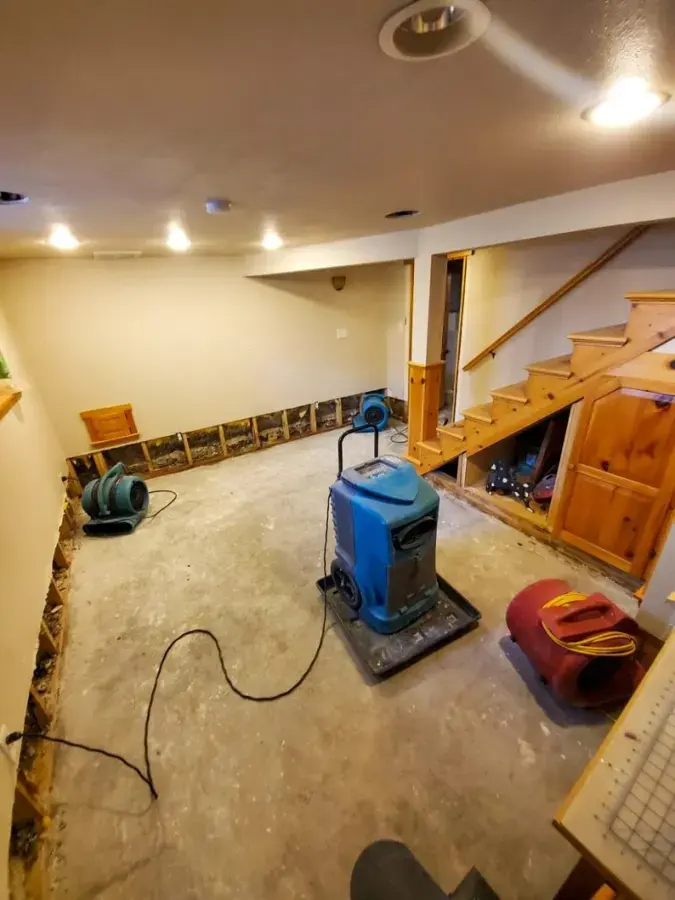 Air movers and a dehumidifier drying a finished room in an Eagan house after a loss